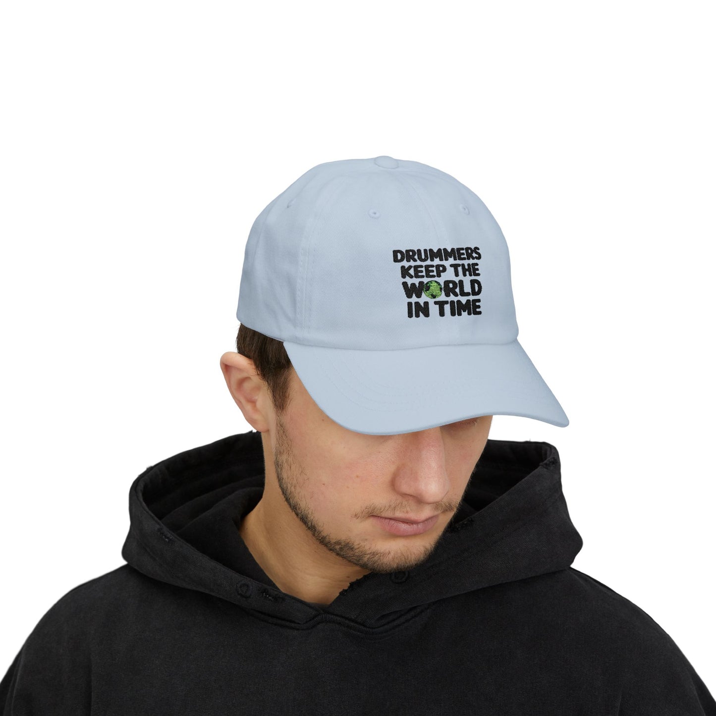 Model wearing a light blue cap with text 'Drummers Keep the World in Time'.